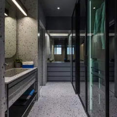 The master bathroom and walk-in closet in 'A Hint of Azul' are finished in a continuous terrazzo surface. The custom-formed sink basin is made from the same material, creating a seamless and monolithic appearance.