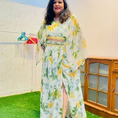 A happy client looking radiant in her custom-made floral kaftan dress. She loved how comfortable and stylish her redesigned saree felt as a new outfit.