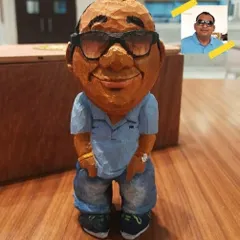 Turning a person's photo into a 3D wooden caricature is my specialty. This piece highlights how I translate a 2D image into a tangible figurine, complete with the subject's style, expression, and even their accessories.