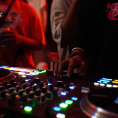 A close-up shot from the first-ever Slw Drift party. My hands on the mixer, feeling the vibe of the room. This is the connection between the DJ and the dancefloor that I live for.