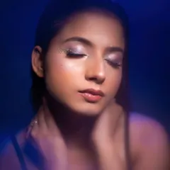 Here we used a cool blue light to create a completely different feel for the same makeup look. This demonstrates how lighting can transform the mood of a beauty portrait from warm to cool and mysterious.