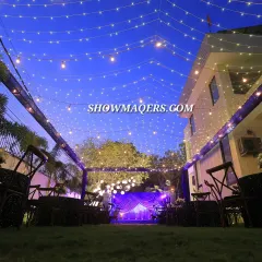 Our capabilities extend to creating beautiful outdoor settings for corporate celebrations and retreats. This evening setup for a retirement party features a canopy of fairy lights and elegant seating, transforming a simple lawn into a magical venue.
