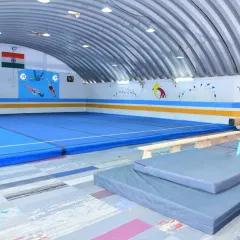 A view of our spacious floor area and balance beams. We ensure our facility is always clean, safe, and ready for our gymnasts to train.