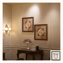 A beautiful double-arm wall sconce with fabric shades illuminates a quiet corner, complementing the vintage world map art. This type of lighting is perfect for adding a soft, ambient glow to a study or reading nook.