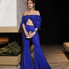 Turning heads in vibrant active blue. A client redefines elegance in this stunning sequined sharara and off-shoulder crop top, a flawless blend of tradition and modern chic.