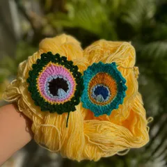 Our MorPankh (peacock feather) design, available as a keychain or a bookmark. The colors are so vibrant and beautiful.