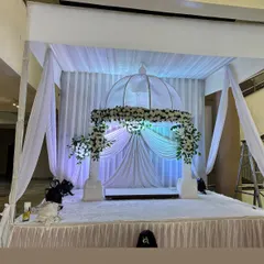 A simple and elegant all-white theme for a Ganpati mandap. This clean look uses white drapes, white flowers, and soft lighting to create a peaceful and serene atmosphere.