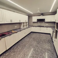 Another angle of the Gurgaon kitchen, showing the extensive cabinetry and countertop space. We ensure every kitchen has a practical layout, with dedicated zones for cooking, cleaning, and storage.