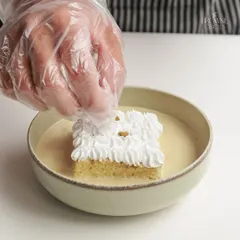 A close-up of our Pistachio Tres Leches being prepared. The creamy pistachio-infused milk soaks into the light sponge for a truly divine flavor.