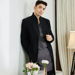 Paired with a grey textured kurta, the black Indo-Western jacket offers a sophisticated, layered look. It's an offbeat and elegant choice for any evening celebration.