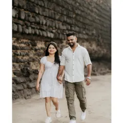 A relaxed walk along the beach, capturing a casual and happy moment between the couple.