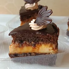 Here's a cross-section of my Crème Brûlée Chocolate Layer Cake. You can see the distinct layers of moist chocolate cake, creamy crème brûlée custard, and a rich chocolate ganache.