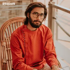 Experience the fusion of modern design and traditional comfort with our custom kurtas. This rust-orange kurta features a contemporary side-placket with loop buttons, offering a stylish and unique option for casual gatherings and festive occasions.