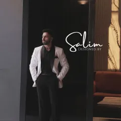 A client in a classic white tuxedo jacket with a black shawl lapel, paired with a black shirt. This monochrome look is effortlessly cool and sophisticated.