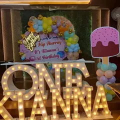 A sweet candyland-themed first birthday with large light-up marquee letters spelling "ONE" and the birthday girl's name, Kianna.