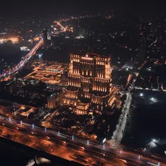 Another aerial perspective of the ITC Royal Bengal in Kolkata at night. This shot provides a wider context of the hotel within the city's glowing grid, emphasizing its status as a landmark.
