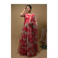 A full view of the flowing red and mint floral organza gown. The tiered skirt and matching dupatta create a dreamy, romantic silhouette perfect for a reception.