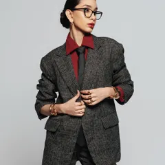 A clean, powerful look for a modern take on power dressing. The bold red lip and sharp, defined features command attention.