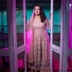 A welcoming pose from my stunning bride. The purple and pink lighting enhances the dreamy quality of her pastel outfit and soft makeup.