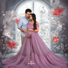 A fairytale moment for this expecting couple. They are framed by our magical winter-themed window prop with giant glowing flowers.