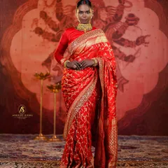 A full-length portrait demonstrating a powerful bridal look against a backdrop depicting Goddess Durga. This setup is perfect for creating culturally rich and divine-themed photographs.