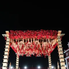 A detailed shot of the mandap's ceiling, covered in a dense layer of red roses with intricate, custom-made hangings that reflect our attention to detail.