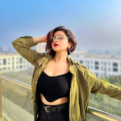A short haircut and a bold attitude. This look with a black crop top and an olive green shacket is all about channeling that confident, baddie energy. Lob, pixie, and mullet are her calling!