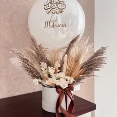 A sophisticated and modern bouquet we curated for Eid. This arrangement uses dried pampas grass and other preserved botanicals in neutral tones, paired with a custom "Eid Mubarak" balloon.