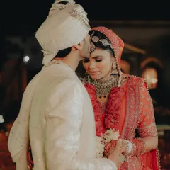 A simple, powerful gesture of love. The groom kissing the bride's forehead after the ceremony is a quiet, intimate moment that speaks volumes.