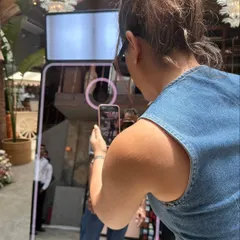 A guest's view of the Magic Mirror. The interactive screen guides you through the process, from striking a pose to instantly sharing your photo via QR code.