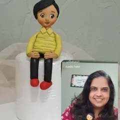 Here I am with one of the fondant figures created during a class. You'll learn to make these impressive toppers to sit on your cakes.