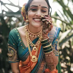 The infectious joy of a Maharashtrian bride. This candid portrait captures a genuine, playful smile, showcasing her beautiful traditional attire and intricate henna details.