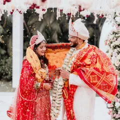 A beautiful moment from a daytime Odia wedding ceremony. As flower petals rain down, the couple shares a look of love and understanding. The soft winter sunlight adds a magical glow to this sacred ritual.