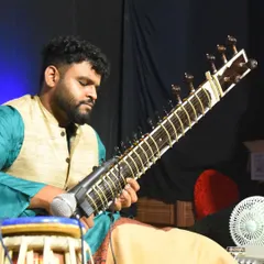 Deep in concentration during a live performance, with a tabla player beside me. This highlights my experience in performing traditional jugalbandi duets.