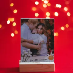 A family photo displayed on a custom wooden stand with the caption "Our little sunshine." These stands are a beautiful way to display treasured family moments.