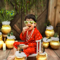 Our natkhat nandlal enjoying a little makhan, with a modern twist. This playful shot combines tradition with a bit of fun, perfectly capturing his mischievous spirit.