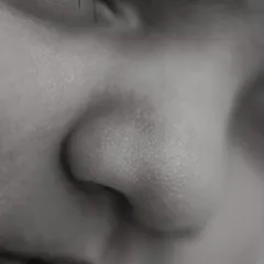 A close-up of a perfect little button nose. These black and white detail shots highlight the delicate textures and features that make your baby unique.