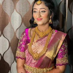 Vidya looking radiant and happy. The half-up hairstyle keeps the hair away from her face while still showing off its length and texture.