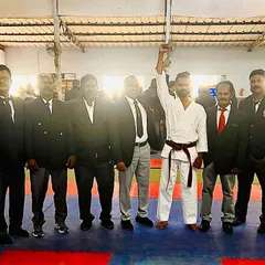 My hand raised by the officials after a successful bout. Competing keeps my skills sharp and my spirit strong, and I bring that fire back to my students.