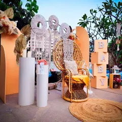 Here is an outdoor boho baby shower setup, showcasing the peacock chair as a throne for the mom-to-be. The combination of natural textures like jute and macrame creates a relaxed and earthy vibe.