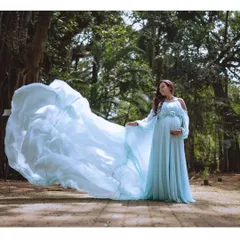 This shot is pure magic. The powder blue flying train gown looks like angel wings in this beautiful garden setting, creating a truly ethereal and unforgettable maternity portrait.