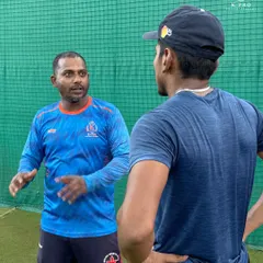 A coach engaged in a one-on-one discussion with a player, providing personalized feedback and strategy. This is the core of our coaching philosophy.