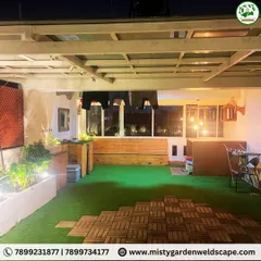 Another view of the 5 star rated terrace project, showing the functional layout with artificial grass, WPC tiles, and custom wooden furniture.