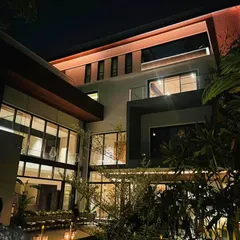 The residence in Koramangala, illuminated at night, showcases how strategic lighting design can transform a home's character and highlight its architectural features.