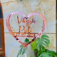 A beautiful heart-shaped topper in rose gold for "Vikash & Priti," personalized with their anniversary date. This design is perfect for celebrating love on anniversaries, engagements, or weddings.
