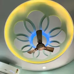 A closer look at the intricate details of the custom ceiling. The combination of the yellow and blue LED lights can be controlled to suit different moods, offering both functional and decorative illumination.