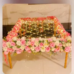 A beautifully decorated 'phoolon ki chaadar' for the bridal entry. This one is made with a canopy of pink and white roses and lit with fairy lights for a magical effect.