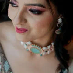 A close-up shot focusing on the bride's stunning makeup and jewelry.