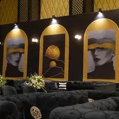 The 'Black Luxe' theme in full swing. We used abstract art panels, plush black velvet seating, and focused spotlights to create a modern and sophisticated lounge area for the Sangeet night.