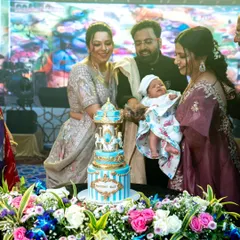 The proud parents celebrating their son's one-month milestone with the grand carousel cake.